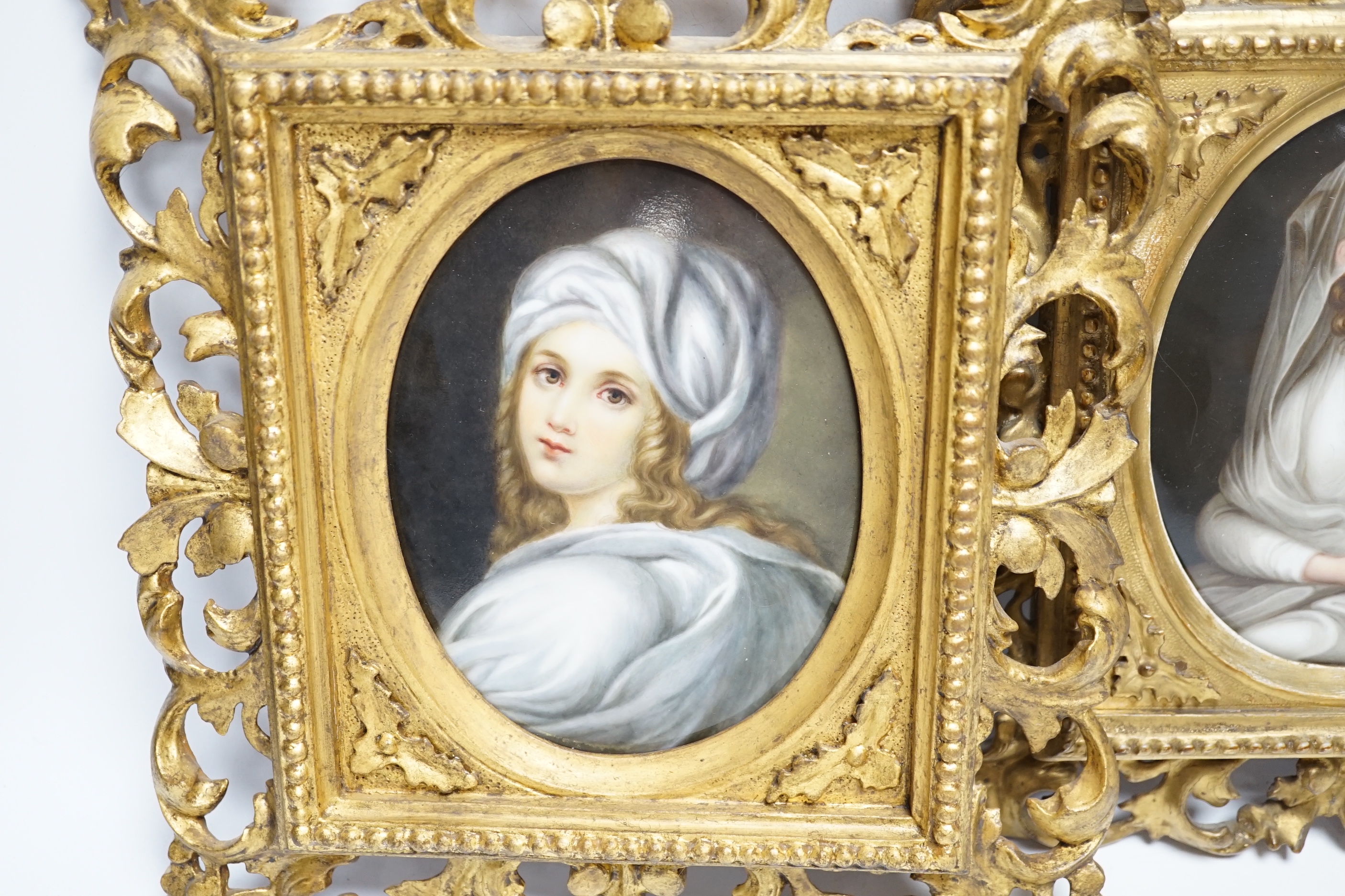 Two 19th century Continental porcelain oval plaques, in similar gilt Florentine frames